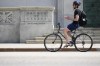 Economists are forecasting inflation fell closer to three per cent, the top end of the Bank of Canada's target range. A cyclist makes their way past the Bank of Canada in Ottawa on Tuesday, July 11, 2023. THE CANADIAN PRESS/Sean Kilpatrick