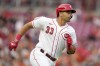 Cincinnati Reds designated hitter Christian Encarnacion-Strand attempts to advance to first base before being tagged out during the second inning of a baseball game against the San Francisco Giants Monday, July 17, 2023, in Cincinnati. It was Encarnacion-Strand's MLB debut. (AP Photo/Jeff Dean)