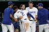 Texas Rangers' Jose Leclerc, left, Marcus Semien (2), Josh Smith, center rear, Corey Seager, right rear, and others celebrate after Smith scored on a wild pitch by Tampa Bay Rays' Pete Fairbanks in the ninth inning of a baseball game, Monday, July 17, 2023, in Arlington, Texas. (AP Photo/Tony Gutierrez)