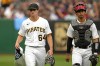 Pittsburgh Pirates starting pitcher Quinn Priester (64) walks from the bullpen after warming up with catcher Endy Rodriguez for their major league debuts in a baseball game against the Cleveland Guardians in Pittsburgh, Monday, July 17, 2023. (AP Photo/Gene J. Puskar)