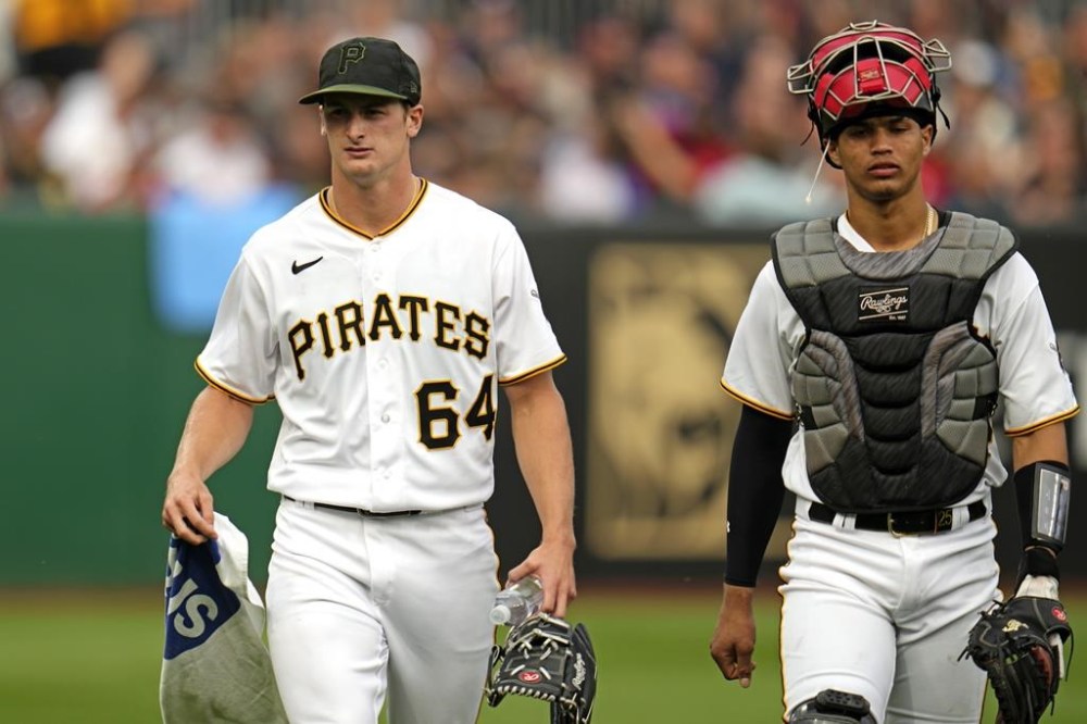 Pittsburgh Pirates starting pitcher Quinn Priester (64) walks from the bullpen after warming up with catcher Endy Rodriguez for their major league debuts in a baseball game against the Cleveland Guardians in Pittsburgh, Monday, July 17, 2023. (AP Photo/Gene J. Puskar)