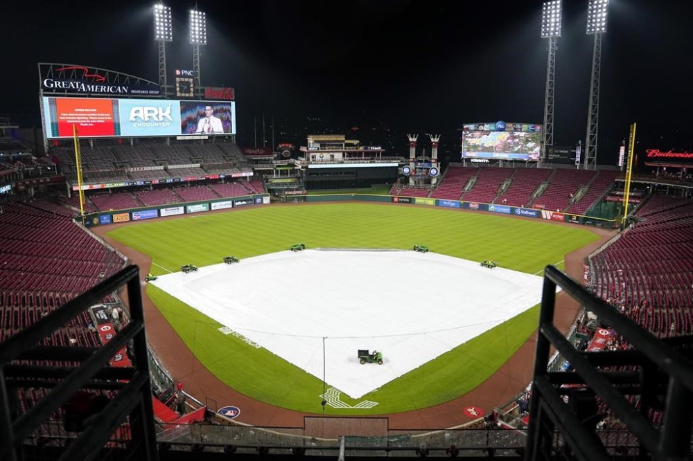 A tarp cover the field during a rain delay in the eighth inning of a baseball game between the San Francisco Giants and the Cincinnati Reds, Monday, July 17, 2023, in Cincinnati. (AP Photo/Jeff Dean)