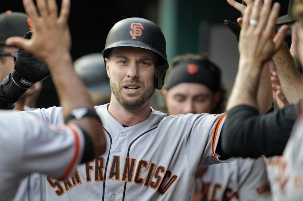 San Francisco Giants' Austin Slater, center, celebrates with teammates after hitting a solo home run against the Cincinnati Reds during the third inning of a baseball game Monday, July 17, 2023, in Cincinnati. (AP Photo/Jeff Dean)