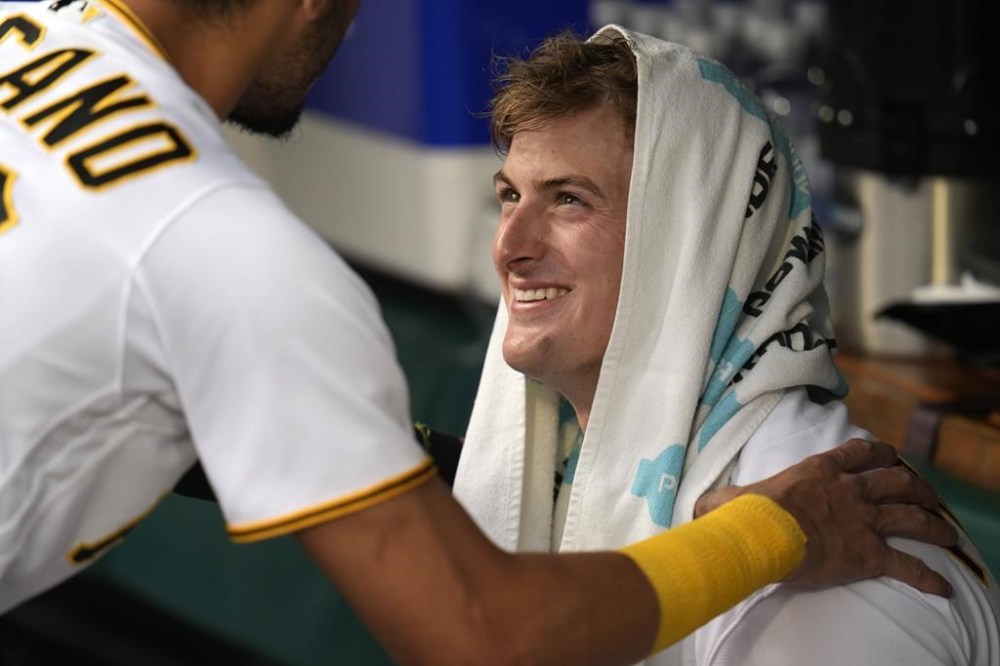 Pittsburgh Pirates starting pitcher Quinn Priester, right, interacts in the dugout with Tucupita Marcano, before taking the field for his major league debut in a baseball game against the Cleveland Guardians in Pittsburgh, Monday, July 17, 2023. (AP Photo/Gene J. Puskar)