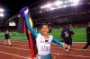 FILE - In this Sept. 25, 2000, file photo, Australia's Cathy Freeman celebrates winning the women's 400 meter race at the Summer Olympics at Olympic Stadium in Sydney. Tony Gustavsson, head coach of Australia's national women's soccer team, called a meeting. Instead of leading the team through a tactical discussion, he told the players he had different plans for the evening.