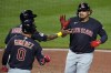 Cleveland Guardians' Josh Naylor, right, heads back to the dugout after hitting a two-run home run off Pittsburgh Pirates relief pitcher Yohan Ramirez during the ninth inning of a baseball game in Pittsburgh, Tuesday, July 18, 2023. (AP Photo/Gene J. Puskar)