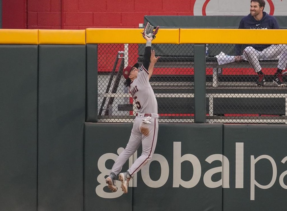 Arizona Diamondbacks center fielder Alek Thomas catches a fly ball from Atlanta Braves' Sean Murphy in the third inning of a baseball game Tuesday, July 18, 2023, in Atlanta. (AP Photo/John Bazemore)