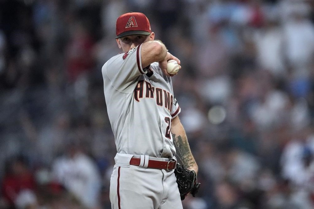 Arizona Diamondbacks starting pitcher Zach Davies (27) waits on the mound for manager Torey Lovullo to relieve him in the fourth inning of a baseball game against the Atlanta Braves Tuesday, July 18, 2023, in Atlanta. (AP Photo/John Bazemore)