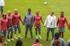Nigeria women's national team head coach Randy Waldrum, second right, stands with his players and staff for a prayer ahead of a practice session in Brisbane, Australia, Tuesday, July 18, 2023. Nigeria will play Canada in their opening Women's World Cup game in Melbourne on July 21. (AP Photo/Katie Tucker)