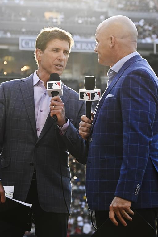 MLB broadcasters Mike Pomeranz, left, and Mark Sweeney work on a broadcast before a baseball game between the Los Angeles Angels and the San Diego Padres on Monday, July 3, 2023, in San Diego. (AP Photo/Denis Poroy)
