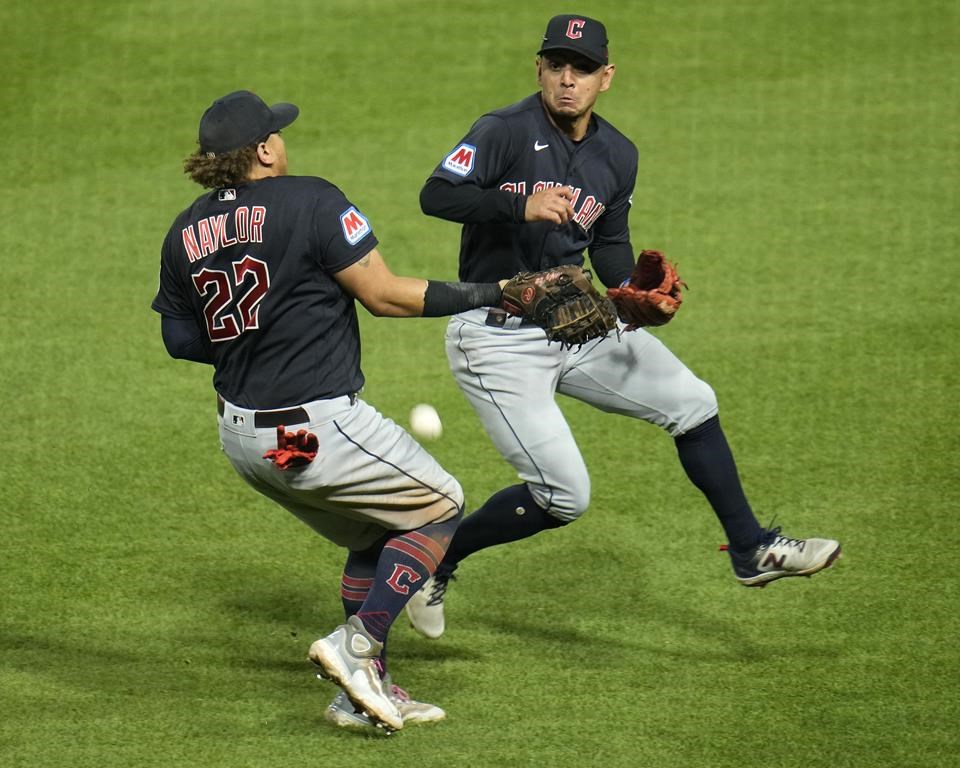 Cleveland Guardians first baseman Josh Naylor (22) and second baseman Andres Gimenez cannot catch a fly ball by Pittsburgh Pirates' Jared Triolo during the ninth inning of a baseball game in Pittsburgh, Monday, July 17, 2023. (AP Photo/Gene J. Puskar)