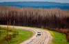A truck passes thorugh a burned section of the East Prairie Metis Settlement, Alta., Tuesday, July 4, 2023.THE CANADIAN PRESS/Jeff McIntosh