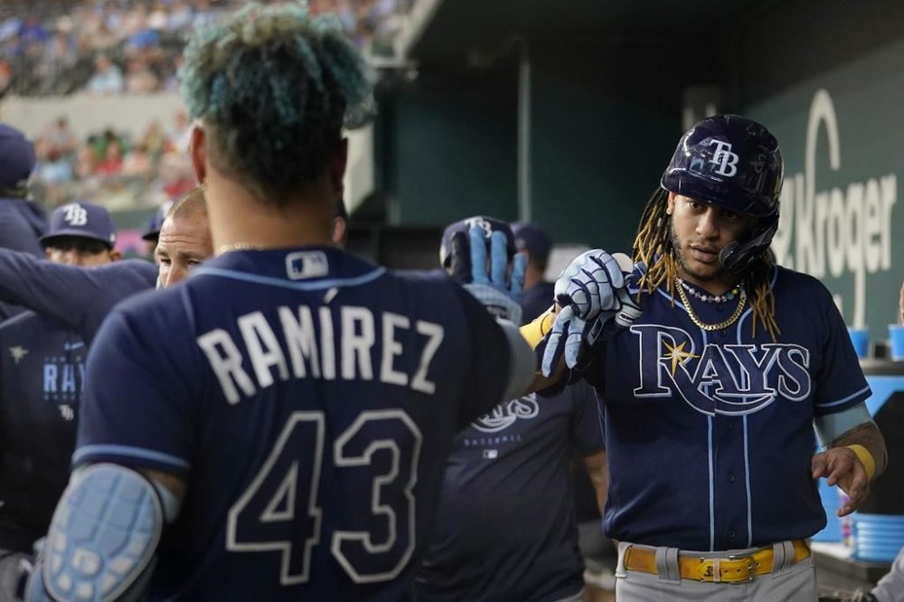 Tampa Bay Rays' Harold Ramirez (43) and Jose Siri, right, celebrate in the dugout after Siri hit a solo home run against the Texas Rangers in the ninth inning of a baseball game, Wednesday, July 19, 2023, in Arlington, Texas. (AP Photo/Tony Gutierrez)
