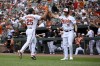 Baltimore Orioles' Anthony Santander (25) gets a high-five from Jordan Westburg (11) after scoring on a single by Aaron Hicks during the first inning of a baseball game against the Los Angeles Dodgers, Wednesday, July 19, 2023, in Baltimore. (AP Photo/Nick Wass)