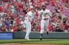 Cincinnati Reds' Will Benson, right, celebrates with third base coach J.R. House after hitting a three-run home run against the San Francisco Giants during the third inning of a baseball game in Cincinnati, Wednesday, July 19, 2023. (AP Photo/Aaron Doster)