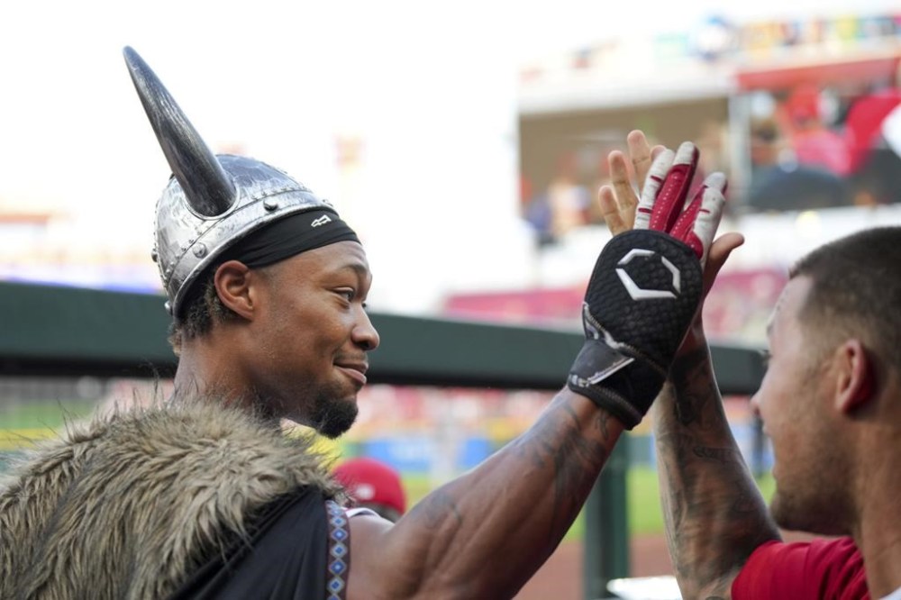 Cincinnati Reds' Will Benson, left, high-fives Nick Senzel after hitting a three-run home run against the San Francisco Giants during the third inning of a baseball game in Cincinnati, Wednesday, July 19, 2023. (AP Photo/Aaron Doster)