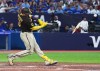 San Diego Padres' Manny Machado (13) breaks his bat on a two-RBI single against the Toronto Blue Jays during fifth inning MLB Interleague baseball action in Toronto on Wednesday, July 19, 2023. THE CANADIAN PRESS/Chris Young