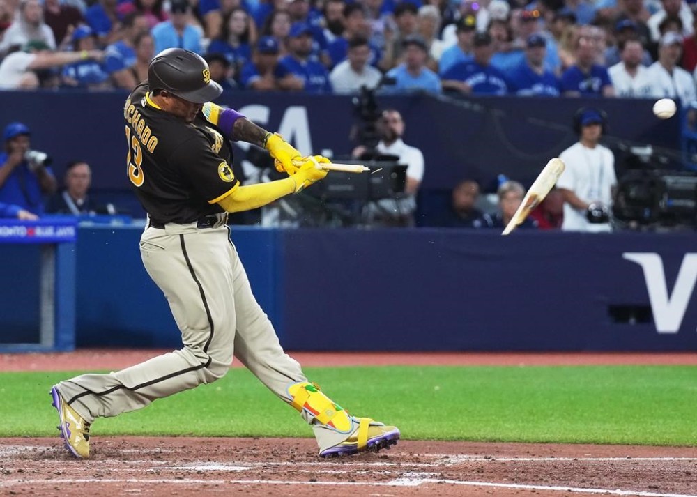 San Diego Padres' Manny Machado (13) breaks his bat on a two-RBI single against the Toronto Blue Jays during fifth inning MLB Interleague baseball action in Toronto on Wednesday, July 19, 2023. THE CANADIAN PRESS/Chris Young