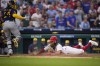 Philadelphia Phillies' Brandon Marsh, right, scores past Milwaukee Brewers catcher William Contreras on a two-run single by Kyle Schwarber during the fifth inning of a baseball game, Wednesday, July 19, 2023, in Philadelphia. (AP Photo/Matt Slocum)