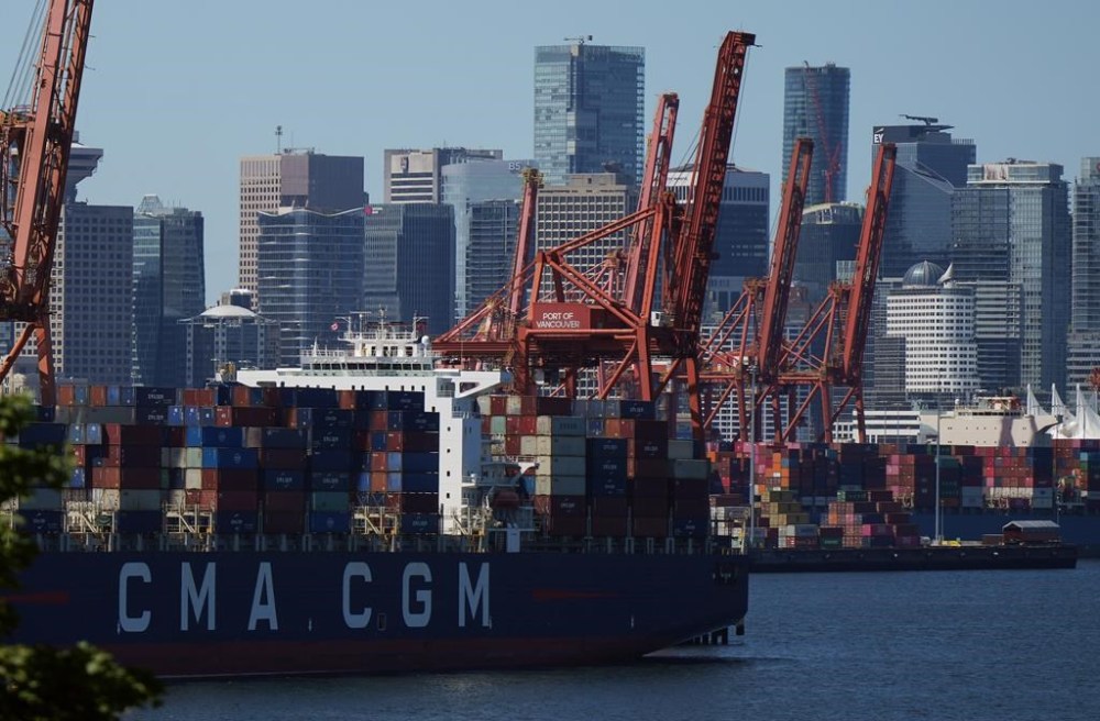 Gantry cranes sit idle as a container ship is docked at port during a work stoppage, in Vancouver, on Wednesday, July 19, 2023.THE CANADIAN PRESS/Darryl Dyck