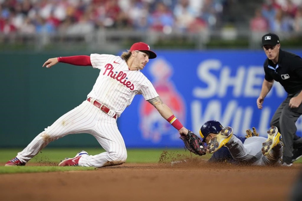 Milwaukee Brewers' Blake Perkins, right, steals second past Philadelphia Phillies second baseman Bryson Stott during the seventh inning of a baseball game, Wednesday, July 19, 2023, in Philadelphia. (AP Photo/Matt Slocum)