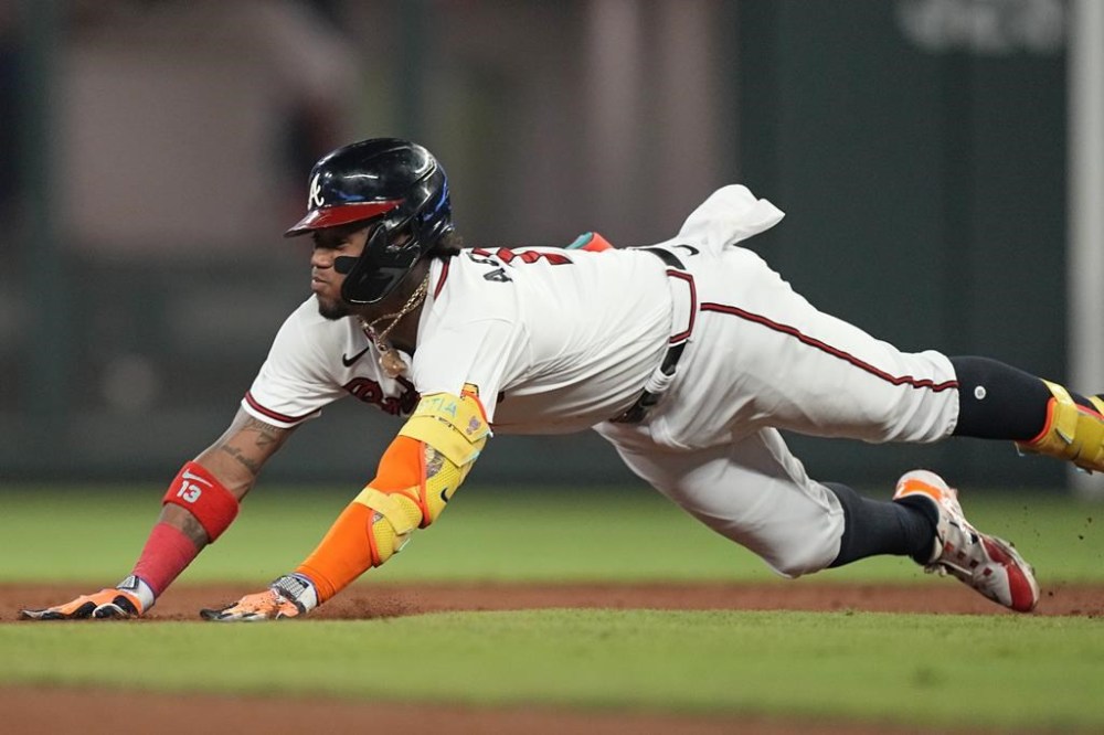 Atlanta Braves' Ronald Acuna Jr. dives into second base with a double against the Arizona Diamondbacks during the ninth inning of a baseball game Wednesday, July 19, 2023, in Atlanta. (AP Photo/John Bazemore)