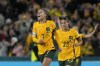 Australia's Steph Catley, left, celebrates after scoring the opening goal from the penalty spot during the Women's World Cup soccer match between Australia and Ireland at Stadium Australia in Sydney, Australia, Thursday, July 20, 2023. (AP Photo/Mark Baker)