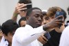 US soccer player Timothy Weah, front, takes a selfie as he arrives for fitness tests at the Italian soccer club Juventus F.C. in Turin, Italy, Thursday, June 29, 2023. (Fabio Ferrari/LaPresse via AP)