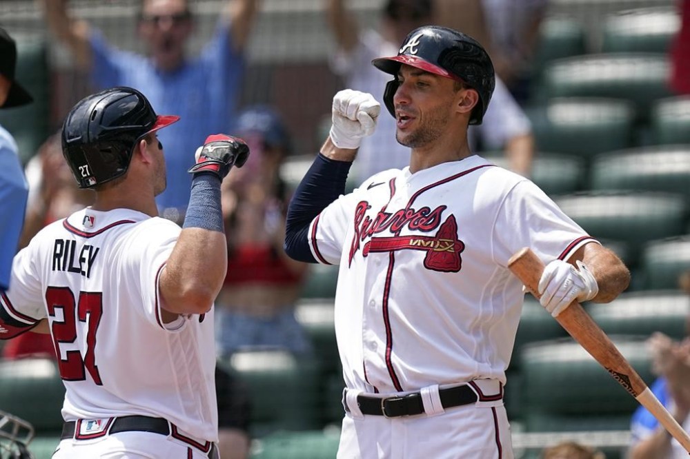 Atlanta Braves' Austin Riley, left, celebrates his three-run home run with Matt Olson in the eighth inning of a baseball game against the Arizona Diamondbacks Thursday, July 20, 2023, in Atlanta. (AP Photo/John Bazemore)