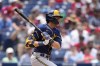Milwaukee Brewers' Christian Yelich follows through after hitting a double against Philadelphia Phillies pitcher Taijuan Walker during the fifth inning of a baseball game, Thursday, July 20, 2023, in Philadelphia. (AP Photo/Matt Slocum)