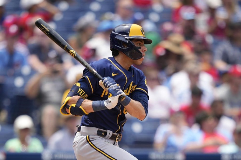 Milwaukee Brewers' Christian Yelich follows through after hitting a double against Philadelphia Phillies pitcher Taijuan Walker during the fifth inning of a baseball game, Thursday, July 20, 2023, in Philadelphia. (AP Photo/Matt Slocum)