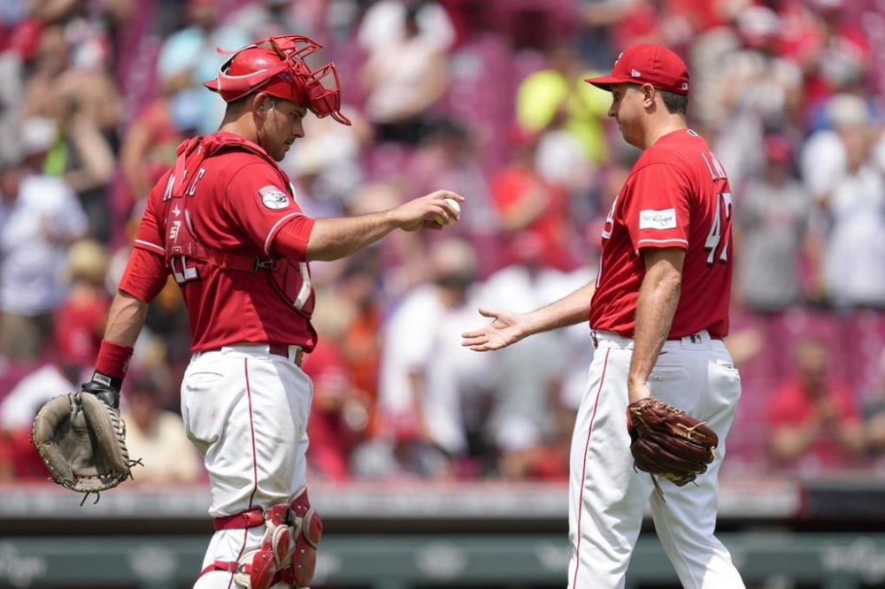 Cincinnati Reds relief pitcher Derek Law, right, celebrates with catcher Luke Maile after a baseball game against the San Francisco Giants, Thursday, July 20, 2023, in Cincinnati. (AP Photo/Jeff Dean)