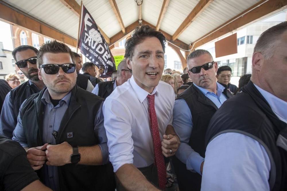 Prime Minister Justin Trudeau surrounded by his security detail in Belleville, Ontario, on Thursday July 20, 2023. THE CANADIAN PRESS/Lars Hagberg