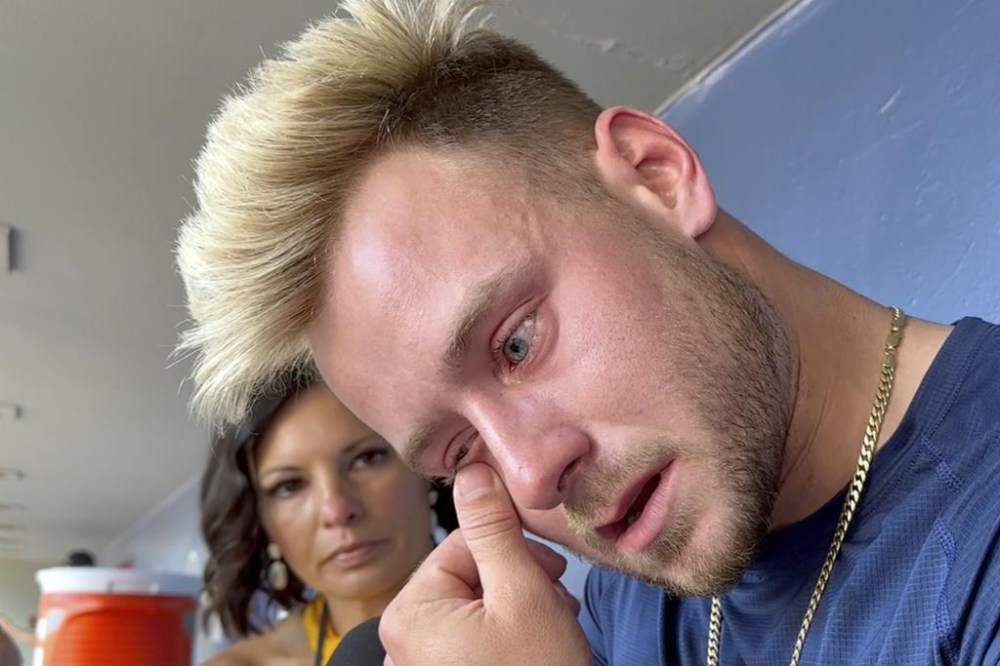 In this image taken from video, Seattle Mariners outfielder Jarred Kelenic gets emotional as he speaks with reporters in the dugout before a baseball game, Thursday, July 20, 2203, in Seattle. Kelenic's emotional outburst after a tough at-bat Wednesday resulted in a damaged water cooler, a broken bone in his left foot and had the Seattle Mariners young left fielder apologizing for his actions. He was placed on the 10-day injured list on Thursday. (AP Photo/Tim Booth)