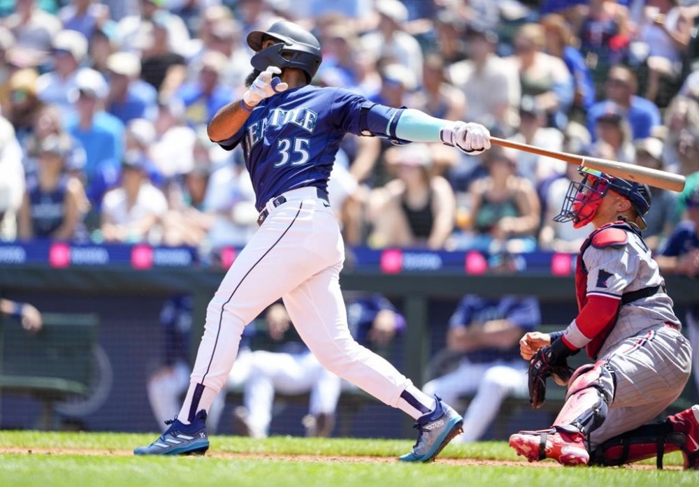 Seattle Mariners' Teoscar Hernandez follows through on a solo home run against the Minnesota Twins during the fourth inning of a baseball game, Thursday, July 20, 2023, in Seattle. (AP Photo/Lindsey Wasson)