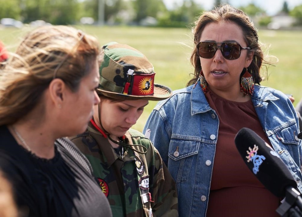 Melissa Robinson (left), the cousin of Morgan Harris, Cambria Harris, the daughter of Morgan Harris, and Chief Kyra Wilson, of Long Plain First Nation, speak to the media near a blockade of the main road into the Brady Road landfill, just outside of Winnipeg, Monday, July 10, 2023. THE CANADIAN PRESS/David Lipnowski