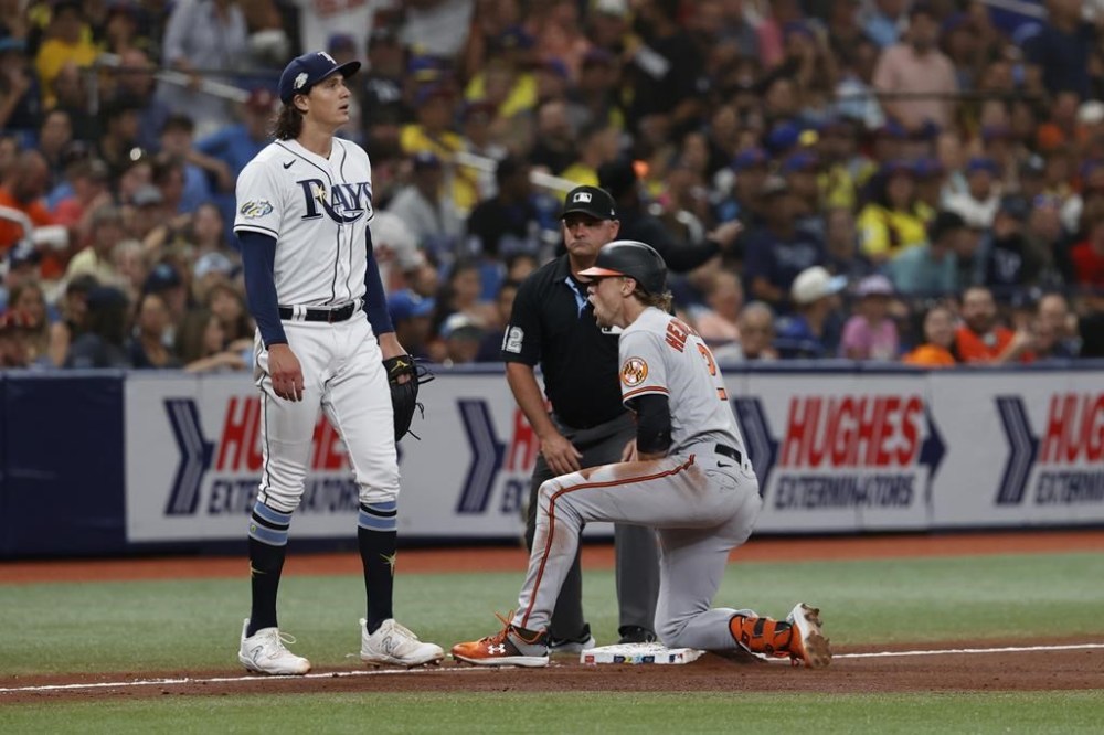 Baltimore Orioles' Gunnar Henderson, reacts next to Tampa Bay Rays pitcher Tyler Glasnow after doubling, and reaching third on a throwing error by Randy Arozarena during the fourth inning of a baseball game Thursday, July 20, 2023, in St. Petersburg, Fla. (AP Photo/Scott Audette)