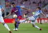 FILE - Real Sociedad's David Silva, right, fights for the ball with Barcelona's Sergio Busquets during a Spanish La Liga soccer match between Barcelona and Real Sociedad at Camp Nou stadium in Barcelona, Spain, Sunday, Aug. 15, 2021. Real Sociedad says that veteran midfielder David Silva has injured a ligament in his left knee. The club says that Silva sustained the injury to his ACL ligament during practice on Thursday, July 20, 23. (AP Photo/Joan Monfort, File)