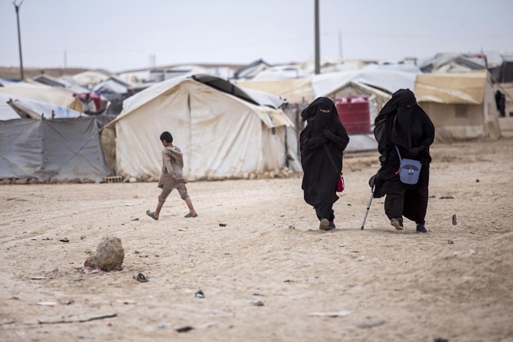 FILE - Women walk in the al-Hol camp that houses some 60,000 refugees, including families and supporters of the Islamic State group, many of them foreign nationals, in Hasakeh province, Syria, on May 1, 2021. A U.N.-backed human rights advocate said Friday July 21, 2023 that hundreds of boys — some as young as 11 — held in detention camps run by U.S.-backed, Kurdish-led forces in northeastern Syria have been wrongly separated from their mothers on the “unproven