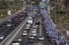 Israelis march along Highway 1 on their way to Jerusalem near Moshav Shoresh in Israel, as part of protests against plans by Prime Minister Benjamin Netanyahu's government to overhaul the judicial system, Friday, July 21, 2023. The protest march from Tel Aviv to Jerusalem is growing as Netanyahu vows to forge ahead on the controversial overhaul. Protest organizers planned to camp overnight at Shoresh, before making their way to Israel's parliament on Saturday. (AP Photo/Ohad Zwigenberg)