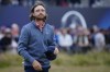England's Tommy Fleetwood acknowledges the crowd after completing his round on the 18th green during the second day of the British Open Golf Championships at the Royal Liverpool Golf Club in Hoylake, England, Friday, July 21, 2023. (AP Photo/Jon Super)