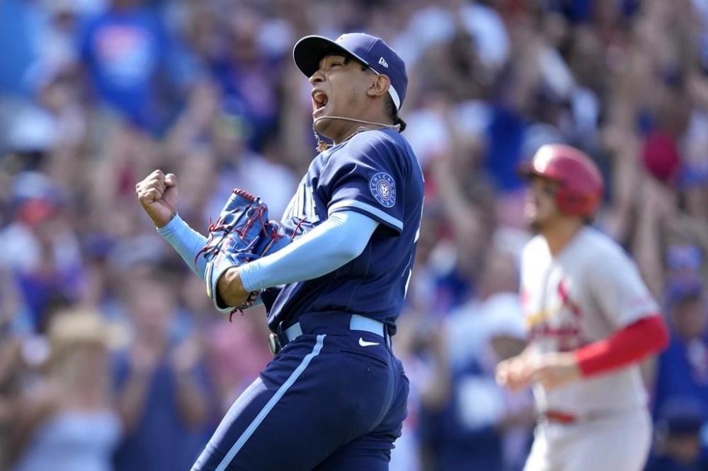 Chicago Cubs relief pitcher Adbert Alzolay celebrates after a win over the St. Louis Cardinals in a baseball game Friday, July 21, 2023, in Chicago. (AP Photo/Charles Rex Arbogast)
