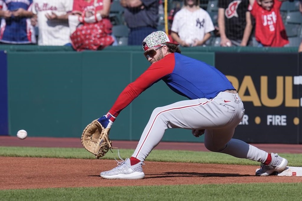 Philadelphia Phillies' Bryce Harper warms up at first base before a baseball game against the Cleveland Guardians, Friday, July 21, 2023, in Cleveland. (AP Photo/Sue Ogrocki)