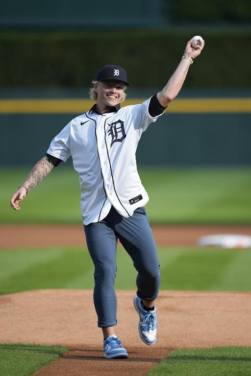 Detroit Tigers first round draft selection Max Clark throws a ceremonial pitch before a Detroit Tigers-San Diego Padres baseball game, Friday, July 21, 2023, in Detroit. (AP Photo/Paul Sancya)