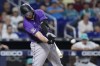 Colorado Rockies' C.J. Cron hits a home run scoring Jurickson Profar, during the first inning of a baseball game against the Miami Marlins, Friday, July 21, 2023, in Miami. (AP Photo/Wilfredo Lee)