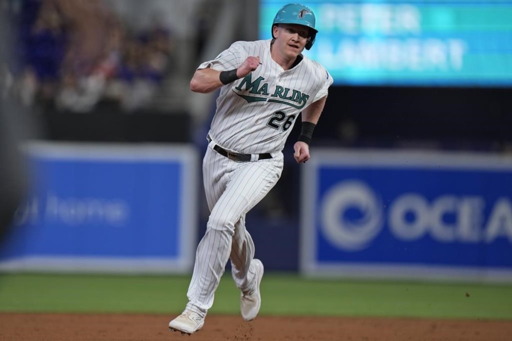 Miami Marlins' Garrett Cooper heads to third base on a double by Jesus Sanchez, during the first inning of a baseball game against the Colorado Rockies, Friday, July 21, 2023, in Miami. (AP Photo/Wilfredo Lee)