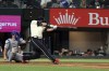 Texas Rangers' Corey Seager, right, hits a home run against the Los Angeles Dodgers in the sixth inning during a baseball game on Friday, July 21, 2023, in Arlington, Texas. (AP Photo/Richard W. Rodriguez)