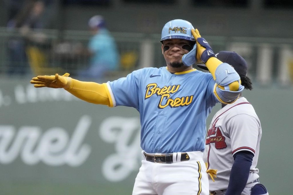 Milwaukee Brewers' William Contreras reacts after hitting an RBI double during the first inning of a baseball game against the Atlanta Braves Friday, July 21, 2023, in Milwaukee. (AP Photo/Morry Gash)