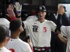 Texas Rangers' Corey Seager (5) is celebrated in the dugout after a solo home run against the Los Angeles Dodgers in the sixth inning during a baseball game, Friday, July 21, 2023, in Arlington, Texas. (AP Photo/Richard W. Rodriguez)