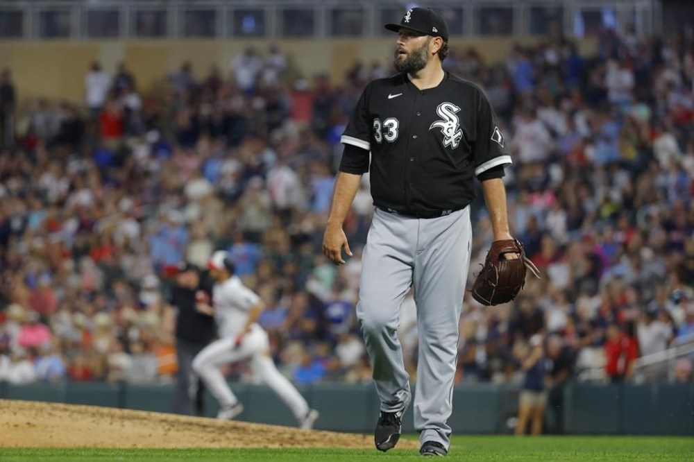 Chicago White Sox starting pitcher Lance Lynn (33) watches the ball from Minnesota Twins' Alex Kirilloff, back left, hit the wall for a two-run double in the seventh inning of a baseball game Friday, July 21, 2023, in Minneapolis. (AP Photo/Bruce Kluckhohn)